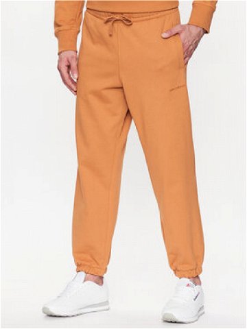 New Balance Teplákové kalhoty MP23551 Oranžová Relaxed Fit