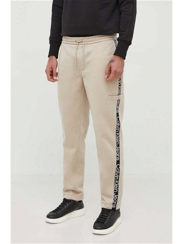 Tepláky Calvin Klein Jeans béžová barva s aplikací