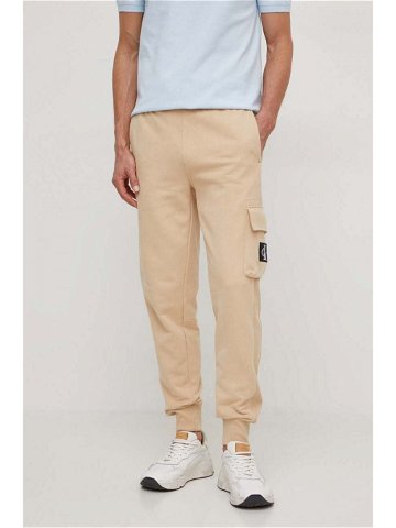 Bavlněné tepláky Calvin Klein Jeans béžová barva J30J324683