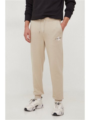 Tepláky Calvin Klein Jeans béžová barva s potiskem J30J324685